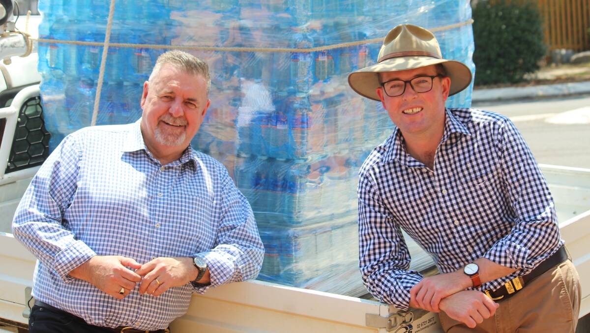 WOES WORSEN: Uralla mayor Michael Pearce and Northern Tablelands MP Adam Marshall with one of the first loads of bottled water trucked into town.