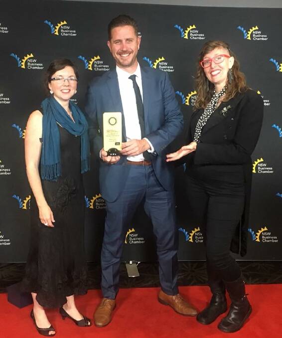 BACKING IT UP: BackTrack's Marcus Watson (middle) claims a top NSW business awards on behalf of the Armidale organisation. Photo: Facebook