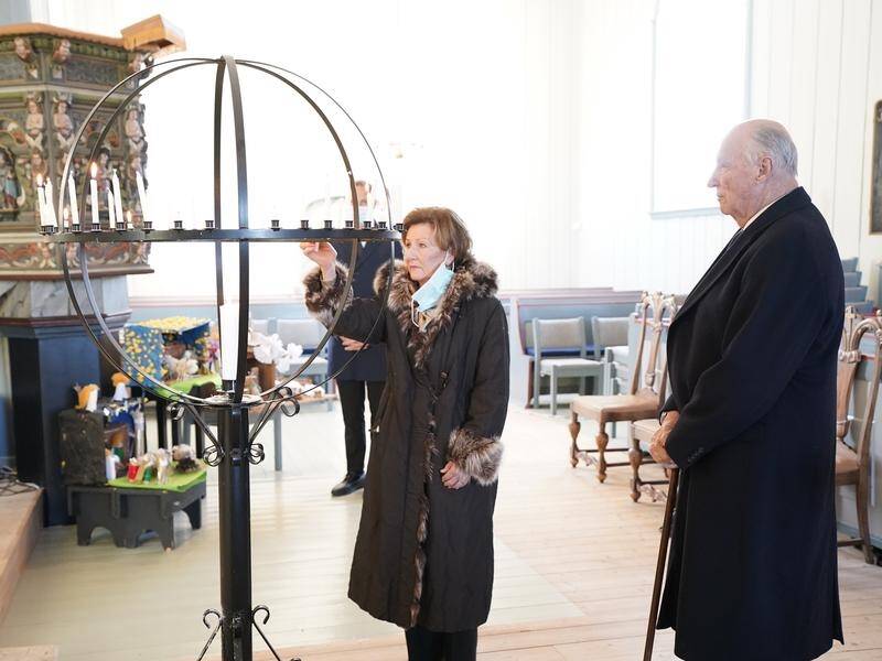 King Harald and Queen Sonja of Norway light candles in Gjerdrum church for the Ask victims.