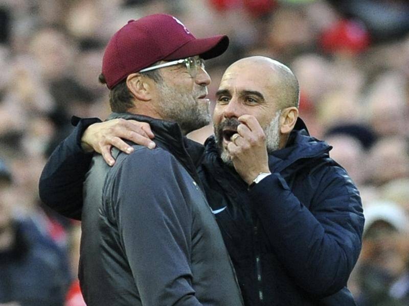 Jurgen Klopp's (l) Liverpool and Pep Guardiola's (r) Manchester City will meet on Sunday at Anfield.