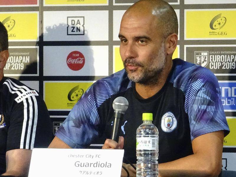 Manchester City manager Pep Guardiola (R) isn't getting fans' hopes up about transfers.