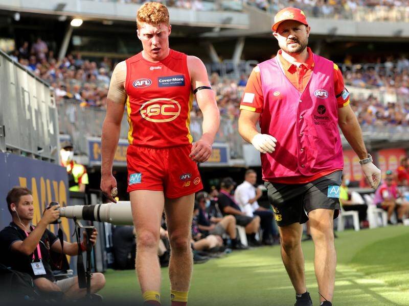 Gold Coast's Matt Rowell, seen leaving the field against West Coast, is expected back in round 14.