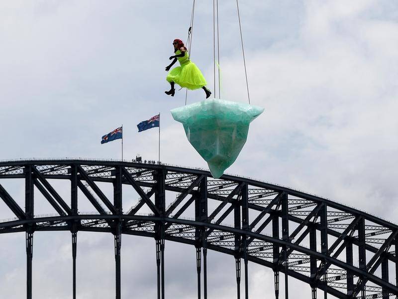 Vicki Van Hout performs on a 2.7-tonne iceberg suspended above Sydney Harbour.