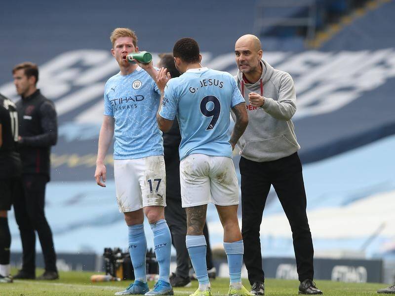 Coach Pep Guardiola urges on Gabriel Jesus and Kevin De Bruyne during Man City's 20th straight win.