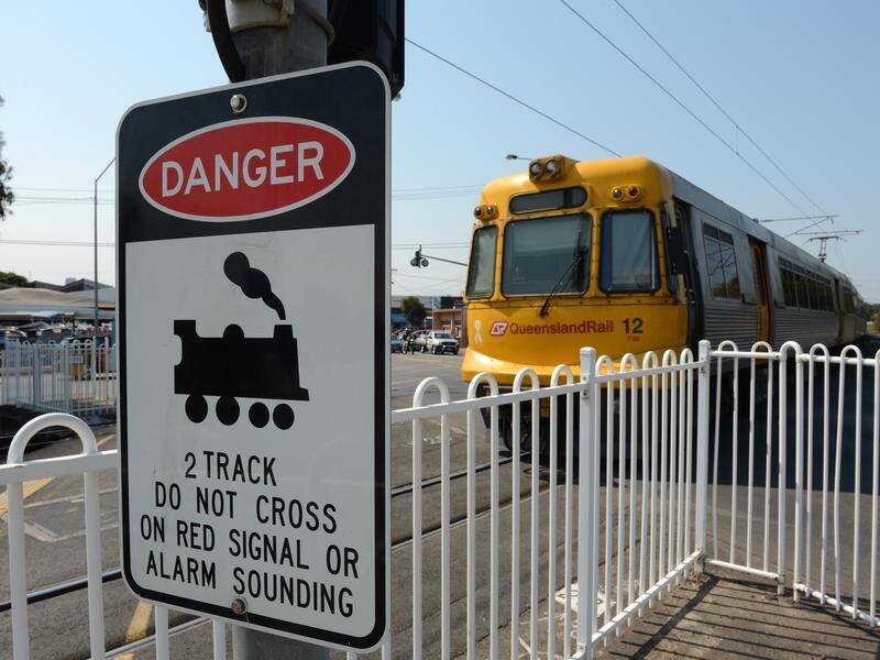 A driver was killed in Brisbane after entering a level crossing when the boom gates were down.