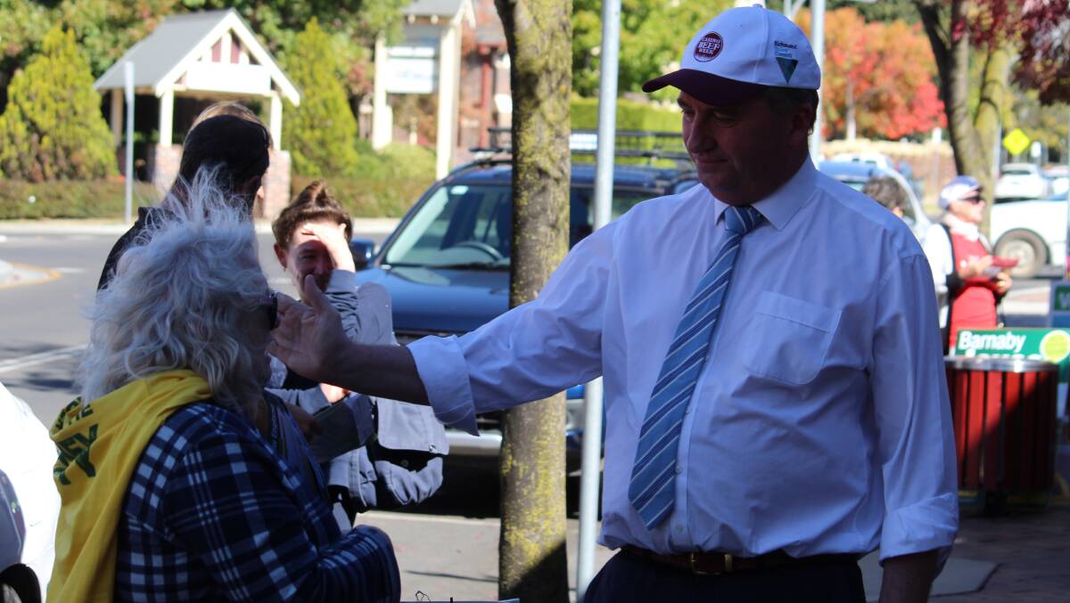 MEETING: Member for New England Barnaby Joyce hands out how to vote cards at Armidale pre-poll and meets his volunteers.