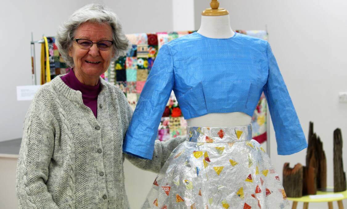 EXHIBITION: Gallery volunteer Glynnis Ellem admires the two-piece recycled plastic outfit on display at this year's waste>art.