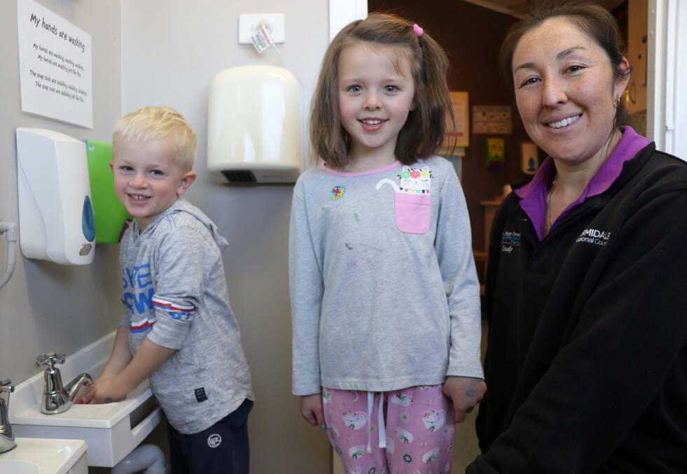 KNOWLEDGE: Guyra long day care centre children Ashton Hutton and Matilda Gray practise their water-wise handwashing with Cindy Mayled.