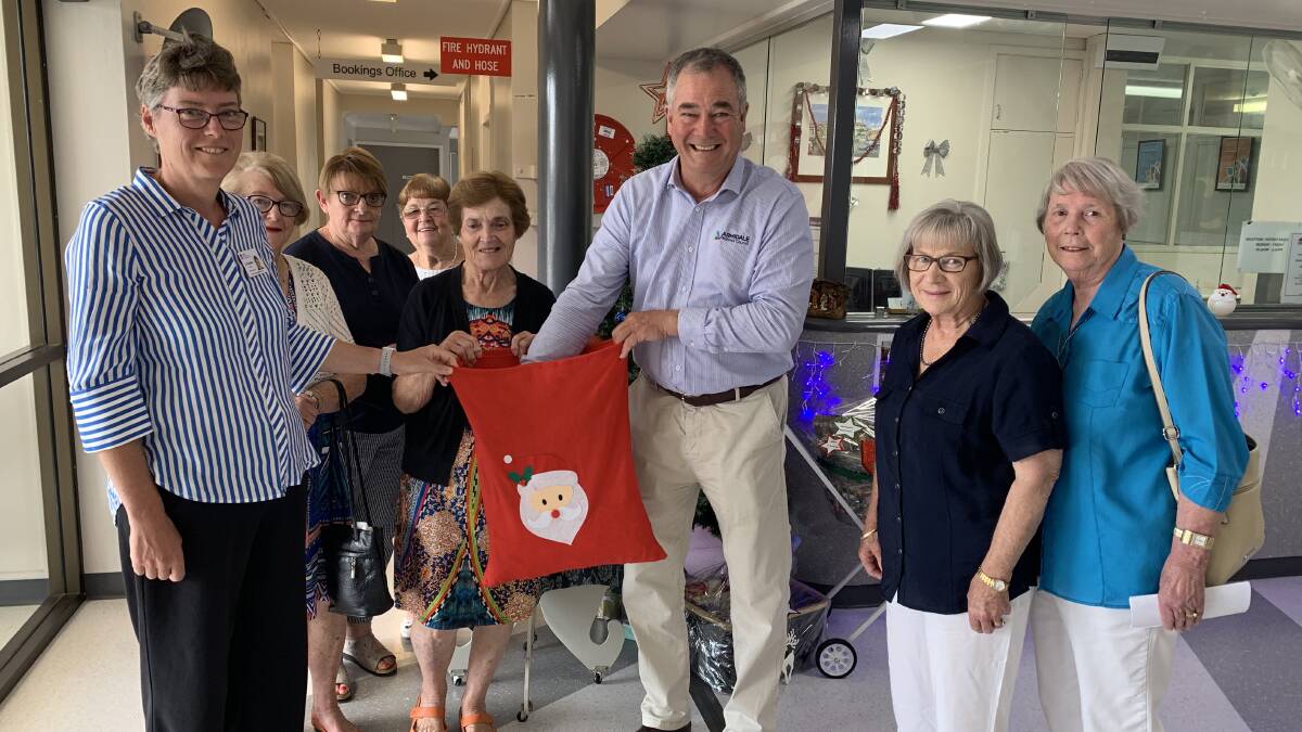 WINNERS: Catharine Death and Armidale Regional council Mayor Simon Murray took turns to draw out the winning tickets while members of the hospital auxiliary look on.