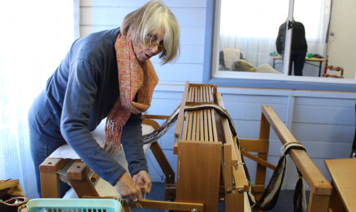 FOUR DECADES: Weaver Margaret Small at work on her machine.