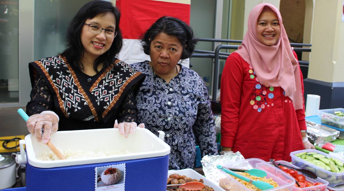 PREPARATION: Agnes Maria Sumargi, Ratna Wijayanti and Febri Ariyanti providing a taste the Indonesian culture they grew up with at last year's culture festival held in Beardy Street Mall at the beginning of December.