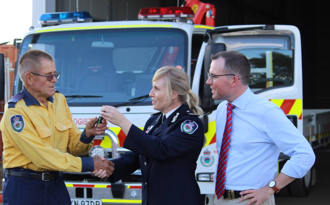 KEYS: RFS volunteer Chris Wilford accepts the keys for the new logistics vehicle  from Assistant Commissioner Rebel Talbert and Member for Northern Tablelands Adam Marshall.