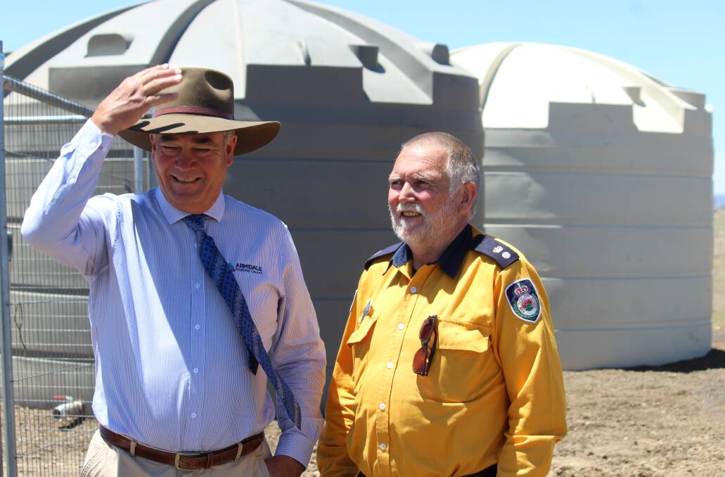 COMMISSIONED: Armidale Mayor Simon Murray with Superintendent Steve Mepham in front of the bore's new storage tanks.