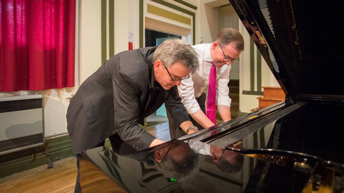 ALL THAT JAZZ: Member for Northern Tablelands Adam Marshall tickles the ivories under the watchful eye of NECOM director Russell Bauer.