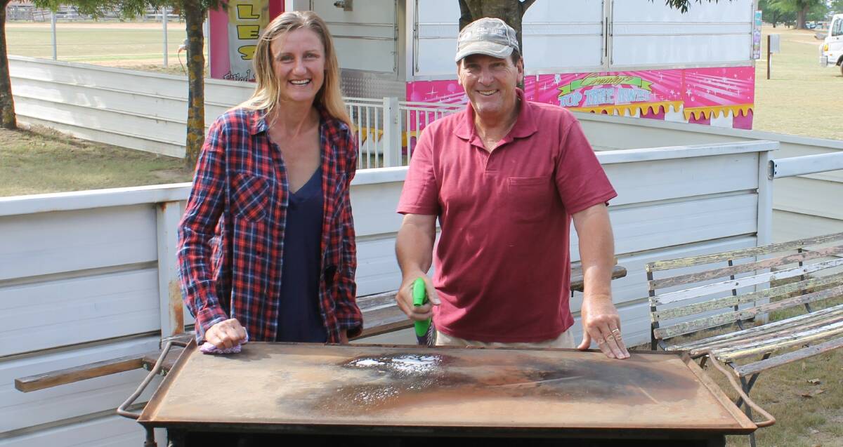 PREPARATION: Uralla Show Society secretary Natasha Ledger and Jeff Scott clean up the barbecues for Saturday's event.
