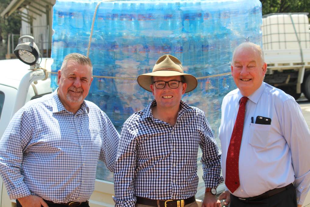 WATER: Uralla Mayor Michael Pearce, Member for Northern Tablelands Adam Marshall and acting general manager David Aber welcomed the first load of bottled water in December.