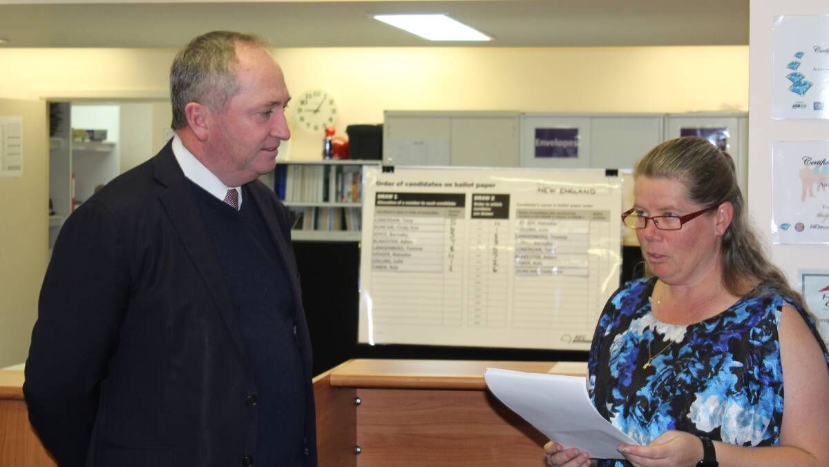 OFFICIAL: Member for New England Barnaby Joyce listens as AEC divisional office manager for New England Yvonne Lea reads the final result.
