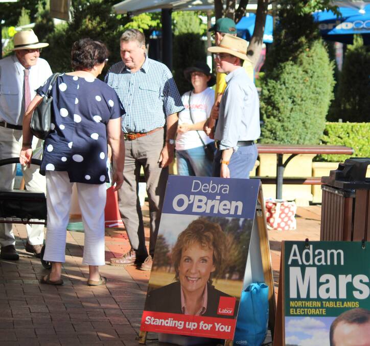 EARLY: Candidates and their representatives were busy on Tuesday morning outside the Armidale pre-poll station.
