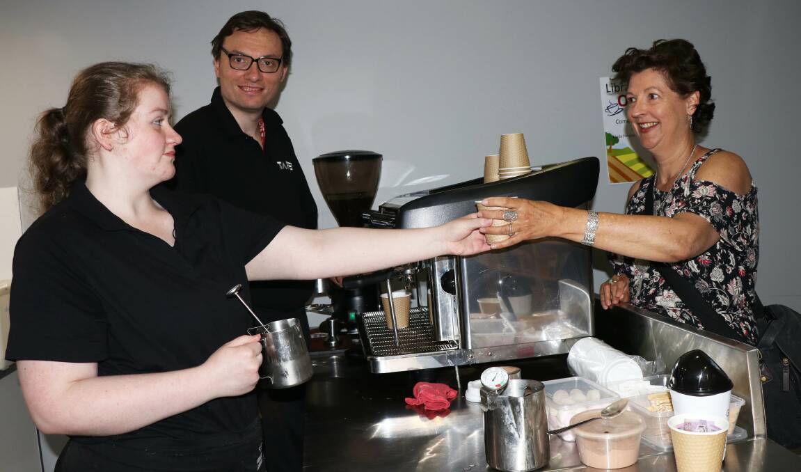 REFRESHMENTS: Armidale Library patron Jo Scotchmer (right) makes the most of the barista skills of TAFE NSW students Kirra-lea Ponsaing and Dominic Keating.