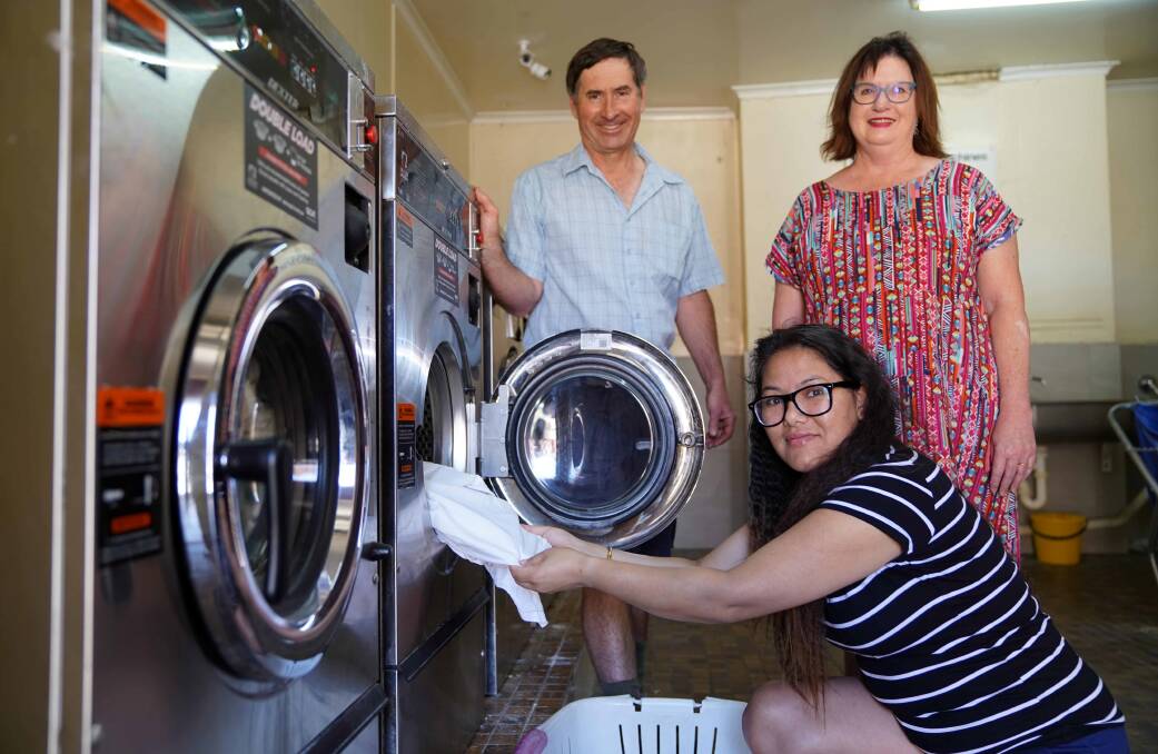 LAUNDRY: Smith House owners Paul Coop and his wife Leigh Fernace with international student Anju Twanabasu.