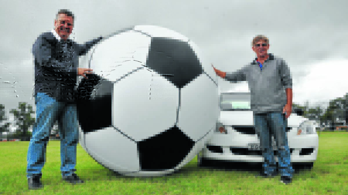 ON THE FIELD: Michael Pearce and Max Schultz in 2015 with the giant soccer ball used in the unique game of car soccer, due to make a return to this year's Uralla Show.