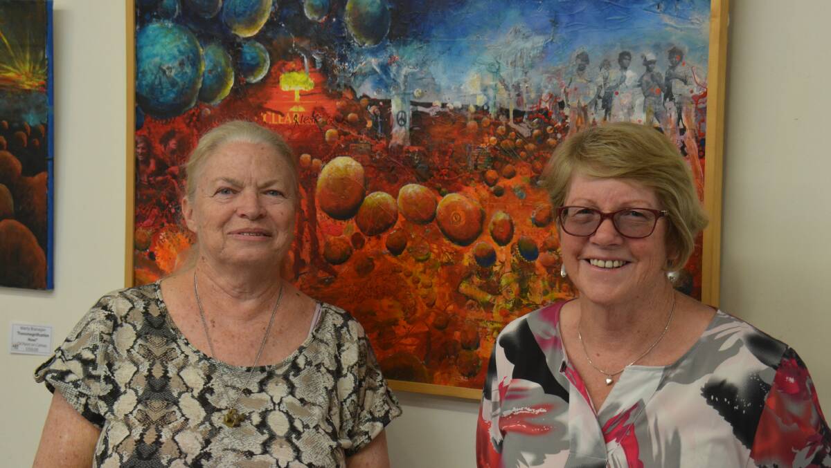 Armidale Art Gallery volunteers Lee Milroy and Lorraine Kellerher were impressed with Marty Branagan's "Clear As Mud".