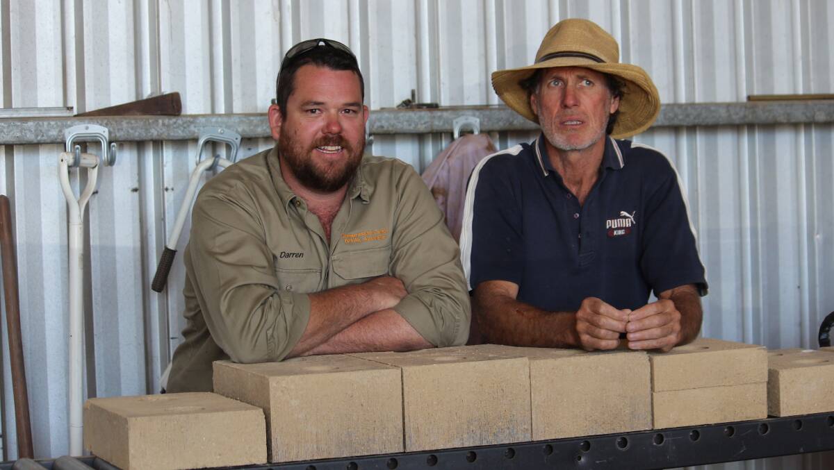 PRODUCTION: Compressed Earth Bricks Australia owners Darren McDonnell and Paul Simmons in their factory with a run of earth bricks they have produced to hopefully construct their display homes. 