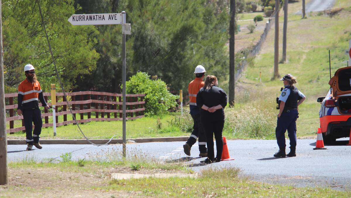 REPAIRS: Members of an Essential Energy team and a police officer were quickly in attendance when the power line came down near Maartin's Gully school.