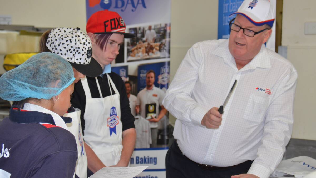 Tony Smith demonstrates the art of meat pie judging.