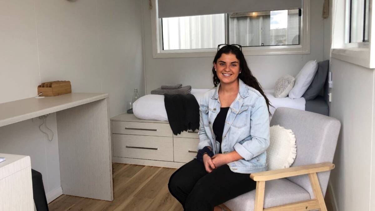SMALL: Amber Vickery sits inside the tiny house she designed for BackTrack.