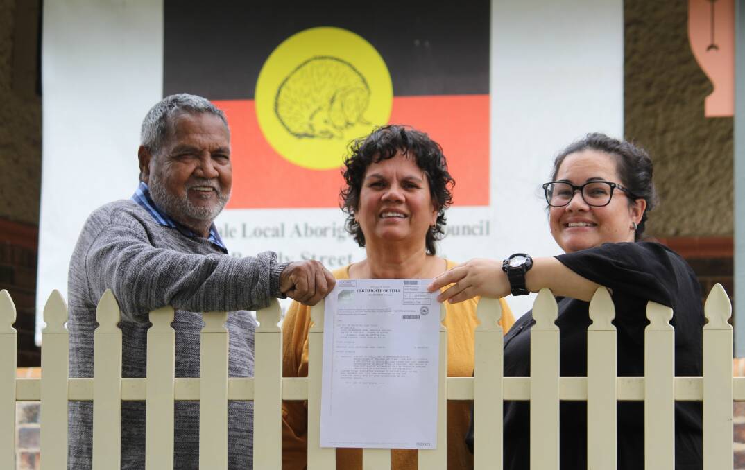 SMALL STEPS: Uncle Colin Ahoy with Jill Ahoy and Armidale Aboriginal Land Council CEO Lisa Waters display the Certificate of Title for the property.
