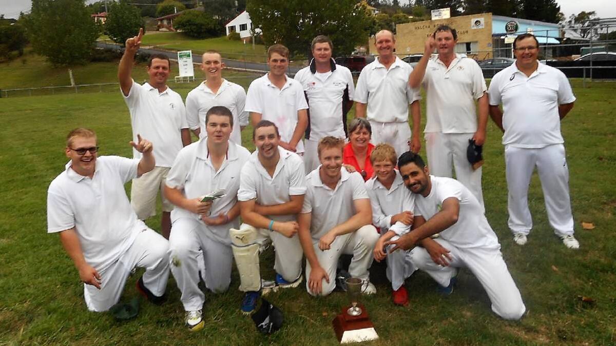 Last year's winners from the Uralla cricket club pose for a photo with the cup.