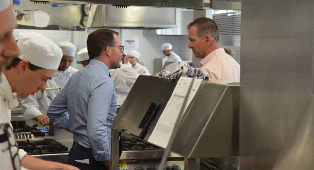 Local MP Adam Marshall chats with Matthew McAlister surrounded by apprentice chefs hard at work on tonight's meal.