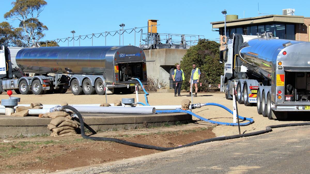 PUMPING OUT: SRH tanker drivers Dave Kennedy and Chris Channells pump water into the output tank at the Guyra Water Treatment Works. 