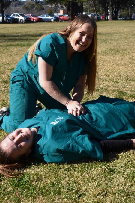 LIFE SAVING EFFORT: Robb College members Alice Woodhill and Liesl Gray are helping save lives by donning their best scrubs to raise    money for the Royal Flying Doctors Service. 
