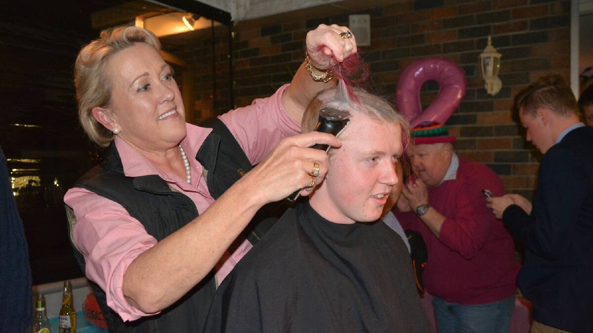 GOOD CAUSE: Belinda Barnes shaves Sam Carmichael’s head at the Head Shave event which was raising money for  the Armidale oncology unit and promoting awareness for male breast cancer.