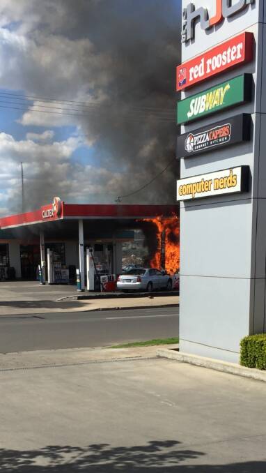 UP IN FLAMES: The service station catching alight after the crash accident occurred.