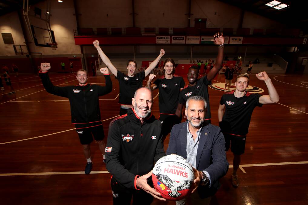 WE ARE BACK BABY: Some of the Illawarra Hawks with coach Brian Goorjian (front left) and president Dorry Kordahi. Picture: Sylvia Liber. 