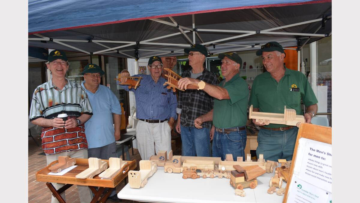 The group from the Mens Shed show off their wooden creations.